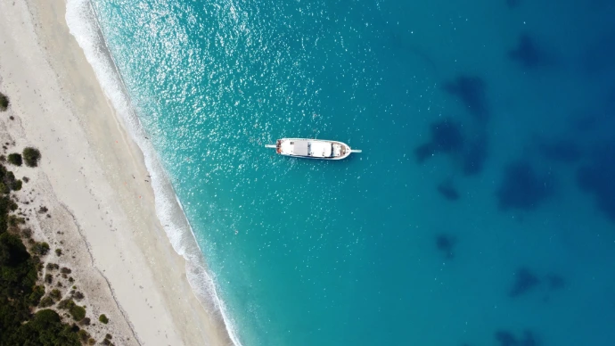 an aerial view of a boat in the water